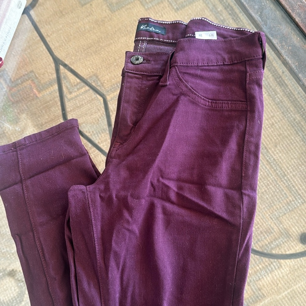 Kancan maroon jeans with distressed knees.